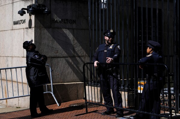 Police officers and a security guard stand outside Columbia University's Hamilton Hall, Wednesday, May 1, 2024, in New York. (AP Photo/Julia Nikhinson)